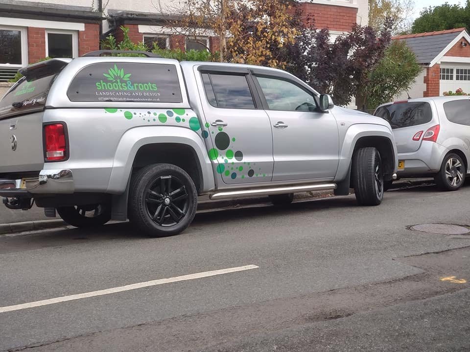The Shoots & Roots Landscaping branded van