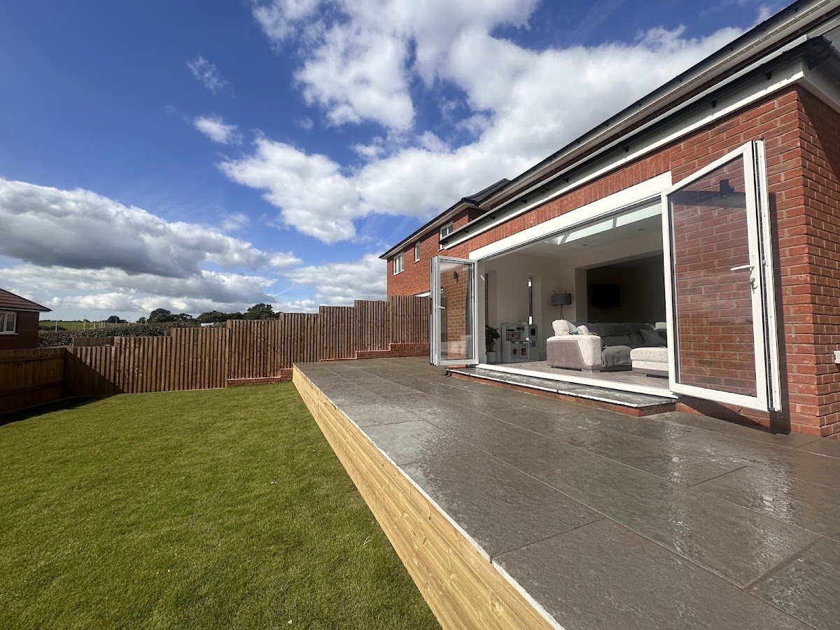 A beautifully landscaped modern garden with patio and lawn by Shoots & Roots